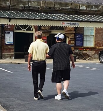 Matt and Ian walking towards the entrance to Filey railway station